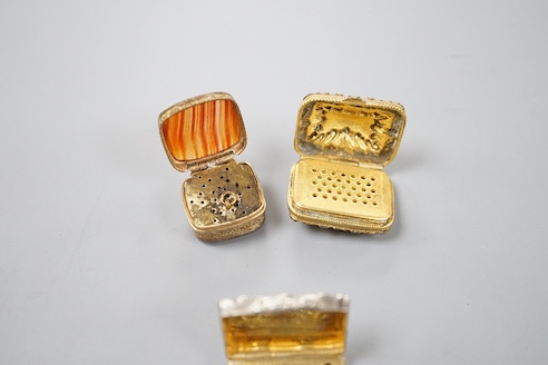 A Victorian engraved silver shaped rectangular vinaigrette, Alfred Taylor, Birmingham, 1850, 27mm and two other gilt metal vinaigrettes, one with inset agate lid.